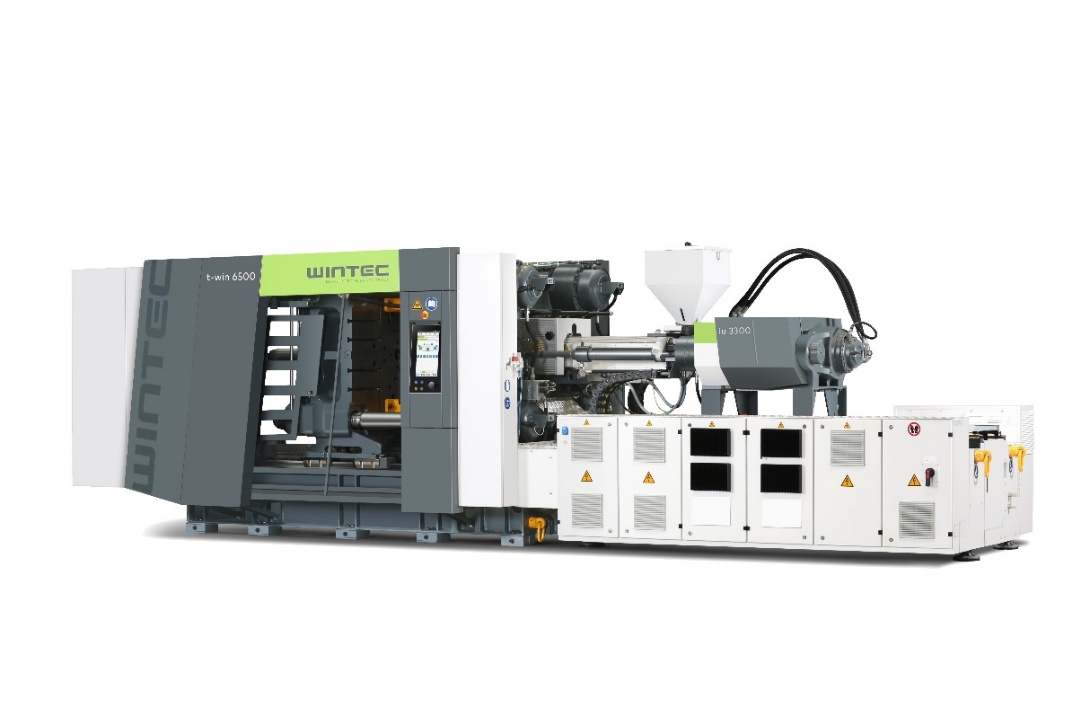 Obrázek ukazuje bílý a šedý dvoudeskový vstřikovací stroj WINTEC t-win